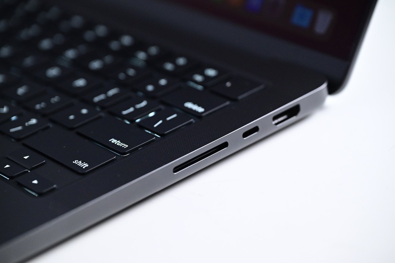 Close-up view of a laptop keyboard and side ports against a white background.