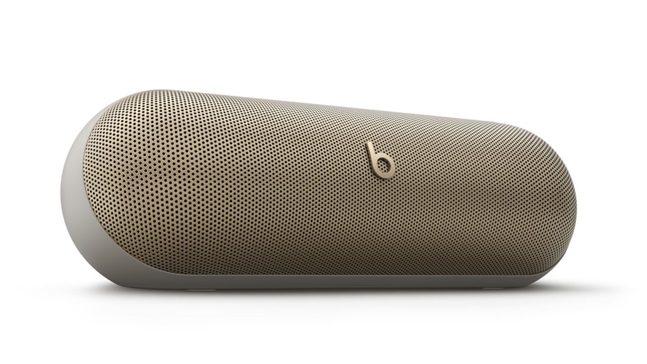 Portable wireless speaker with a sleek, rounded design and perforated metal grille, featuring a small logo in the center.