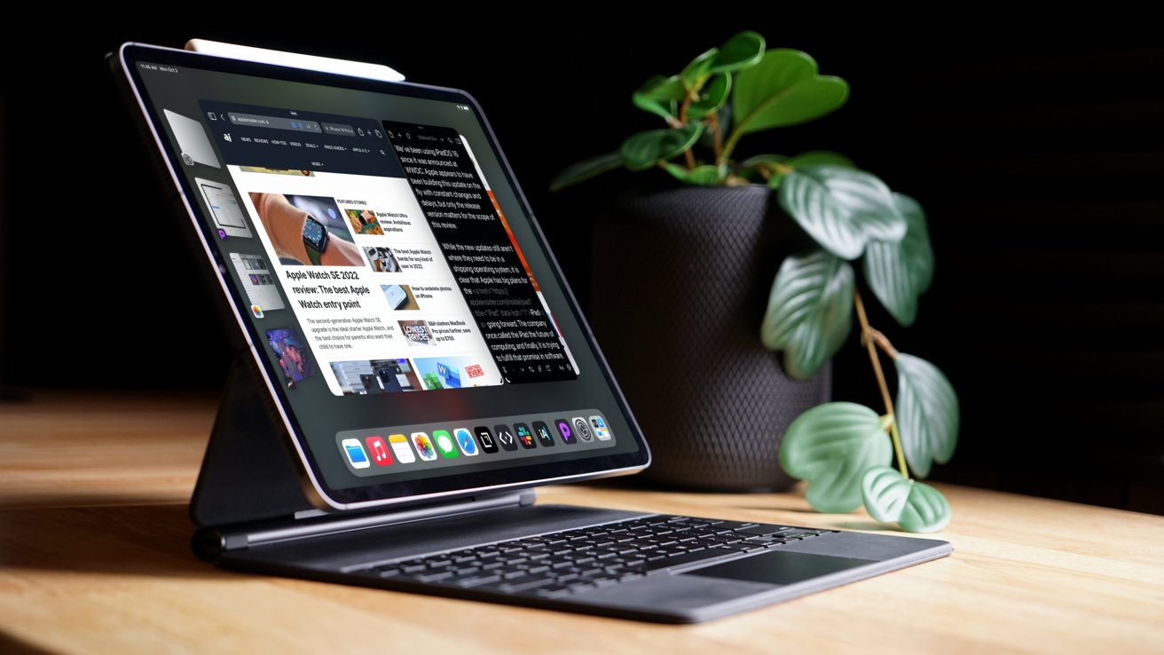 A tablet on a keyboard stand, displaying various apps and websites, with a potted plant in the background.