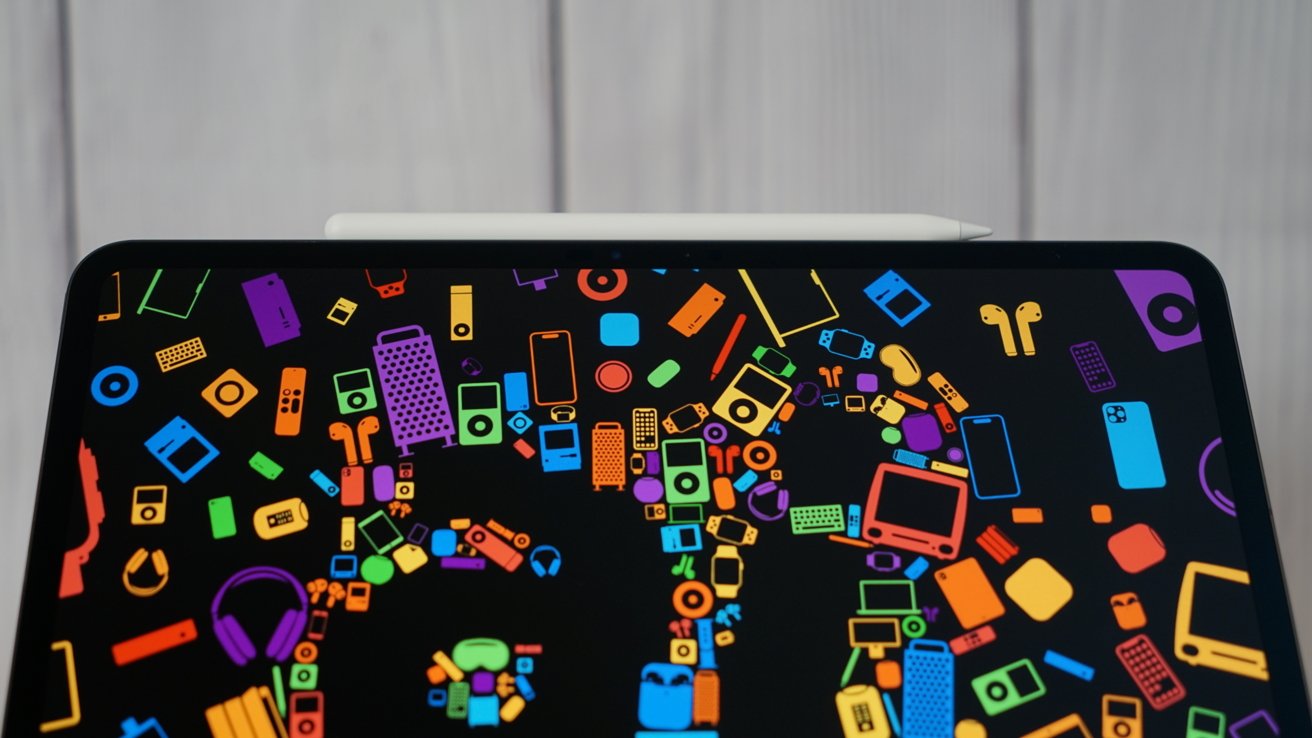 Colorful icons of various electronic devices on a black screen with a white stylus placed on top.