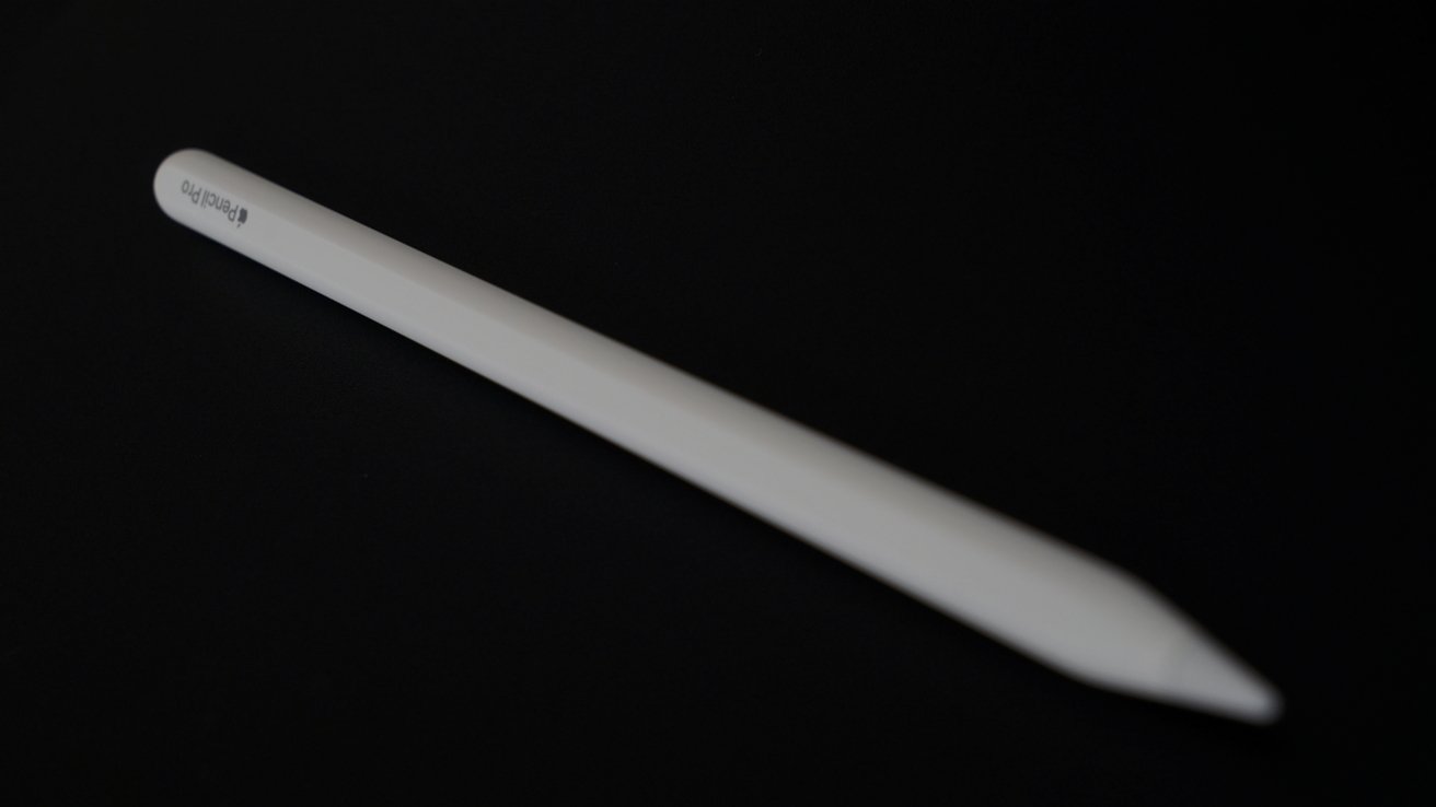 A white stylus pen with a sleek design lies diagonally on a black background.