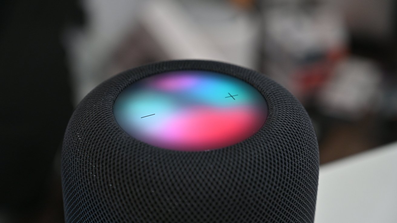 A HomePod with the glowing waveform on top