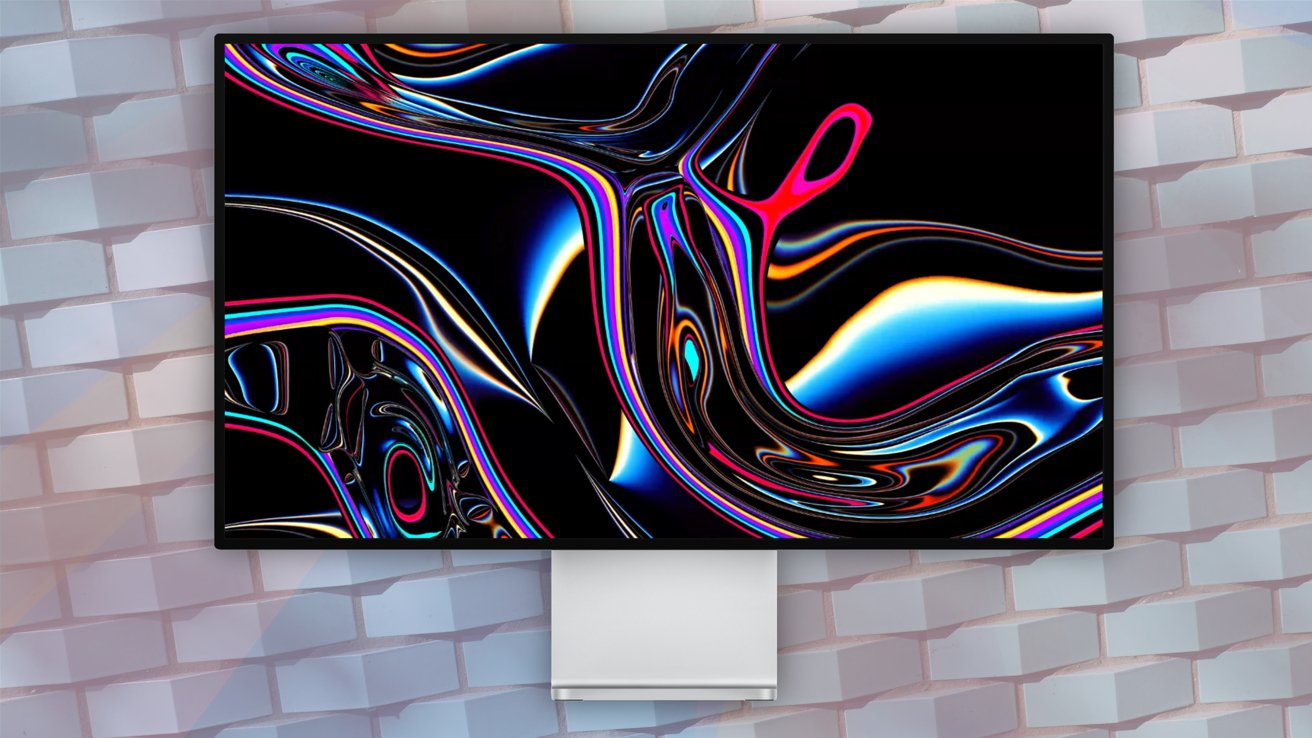 A computer monitor displaying vibrant, abstract swirl patterns on a black background, mounted on a brick wall.