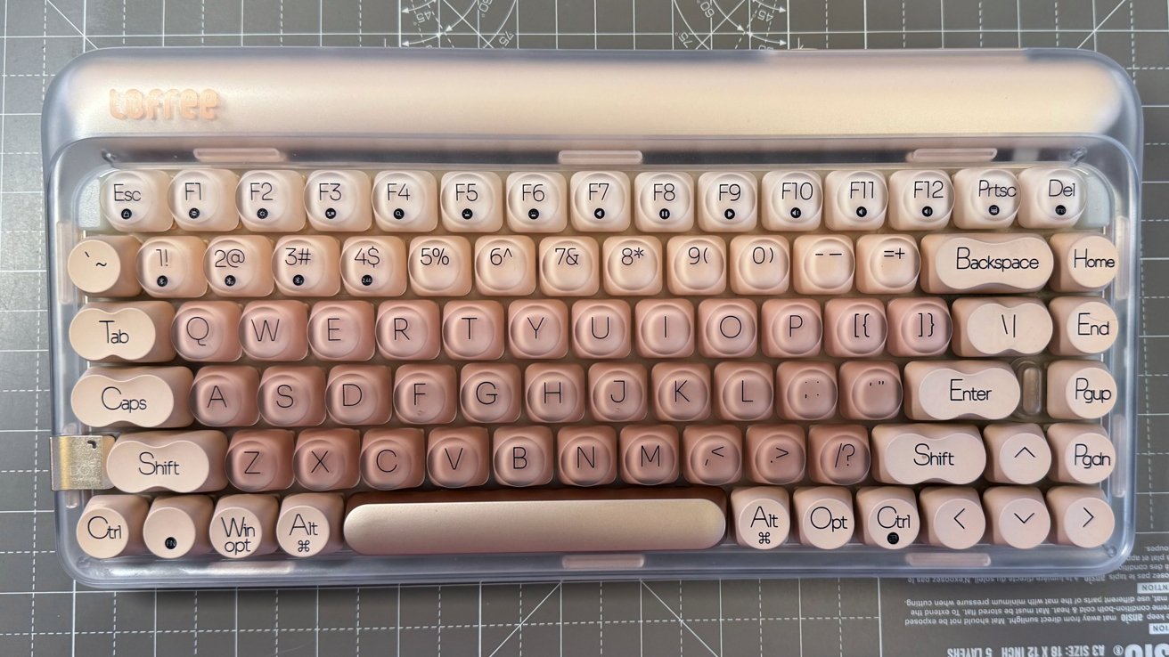 Pink retro-style keyboard with round keys, a silver top panel, and labeled function keys.