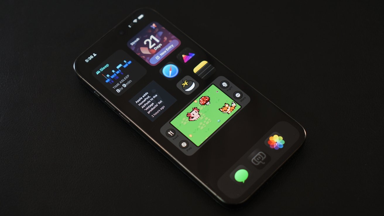 A photo of an iPhone with a black wallpaper and dark icons