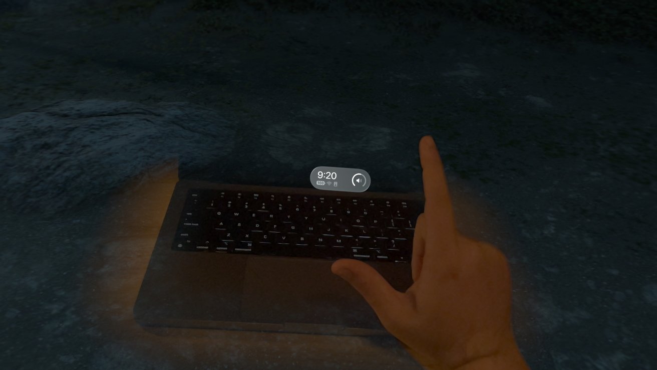 A hand palm down to show the system clock in visionOS with a keyboard visible in the background