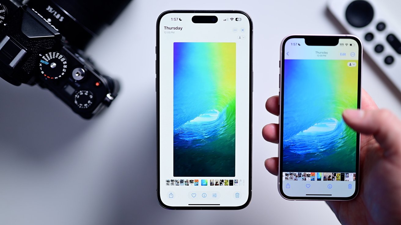 A wallpaper photo of a blue and green wave on two iPhones, one with the new inset interface versus the old interface with bars on the opt and bottom
