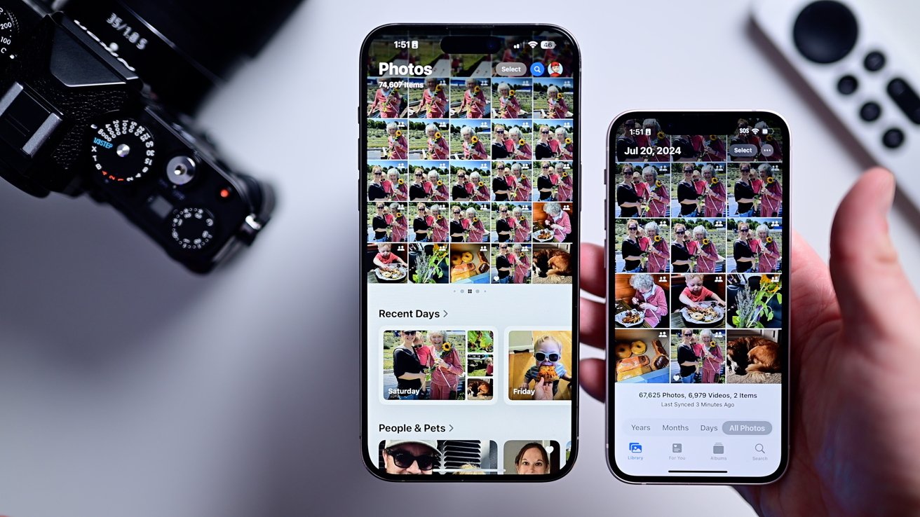 Holding up the library view on iOS 17 compared to a second iPhone running iOS 18 and the new Photos app side by side