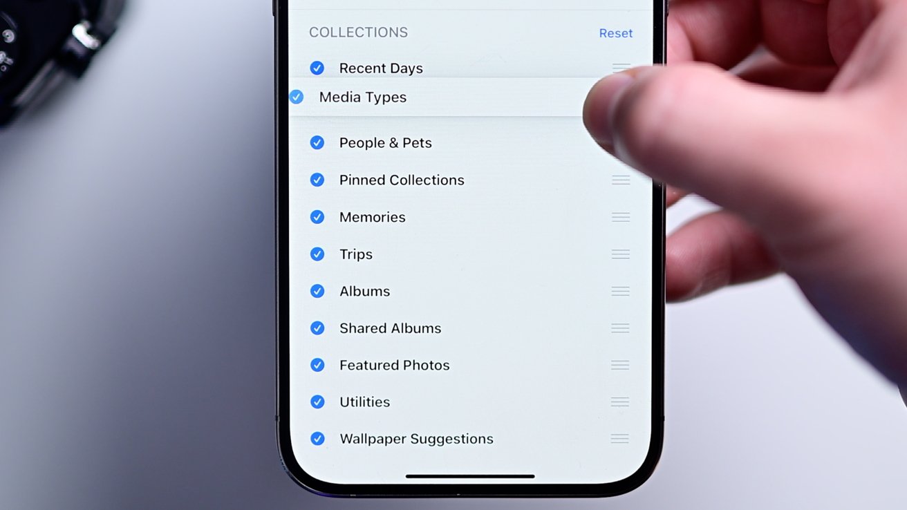 A list of collections in the Photos app that can be rearranged by small slider icons on the right