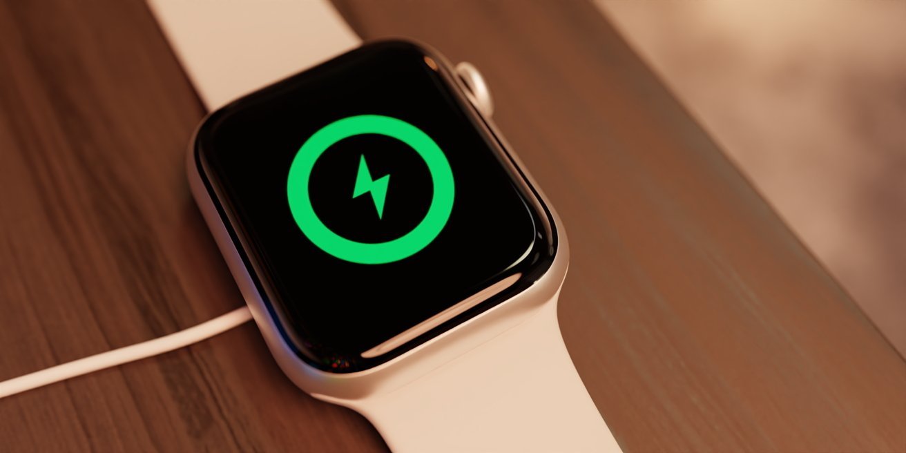 A smartwatch with a white band displaying a green charging icon on its screen, placed on a wooden surface.