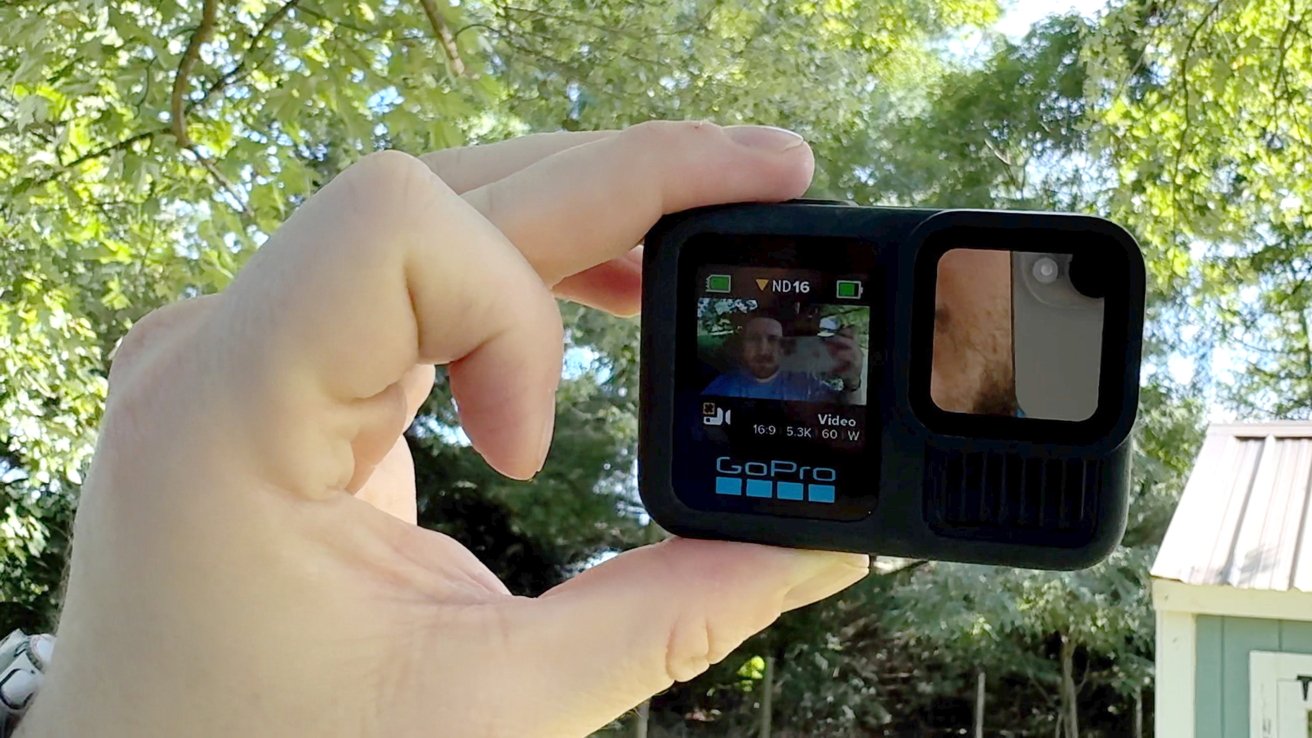 The GoPro Hero 13 Black outside showing a down arrow on the screen saying to adjust the ND filter