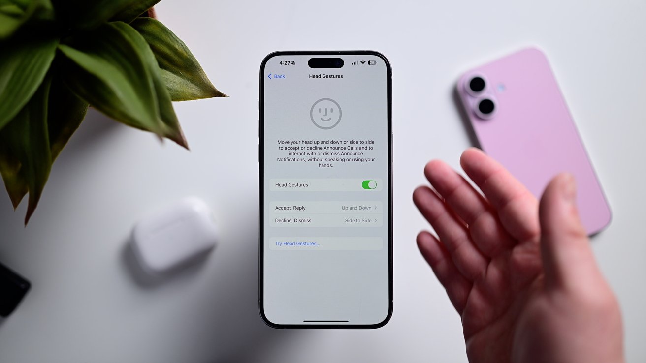 An iPhone on a white table showing the settings for head gestures