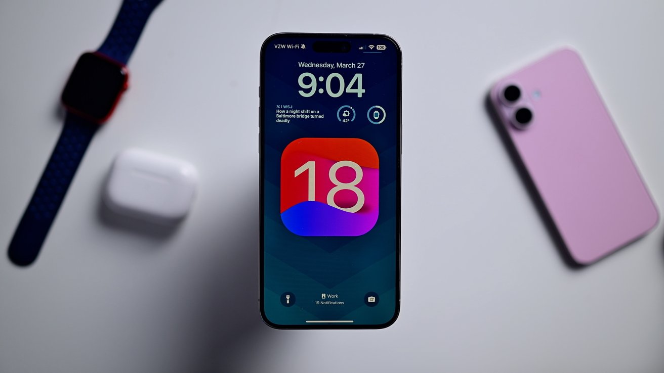 An iPhone on a white table with the iOS 18 update screen