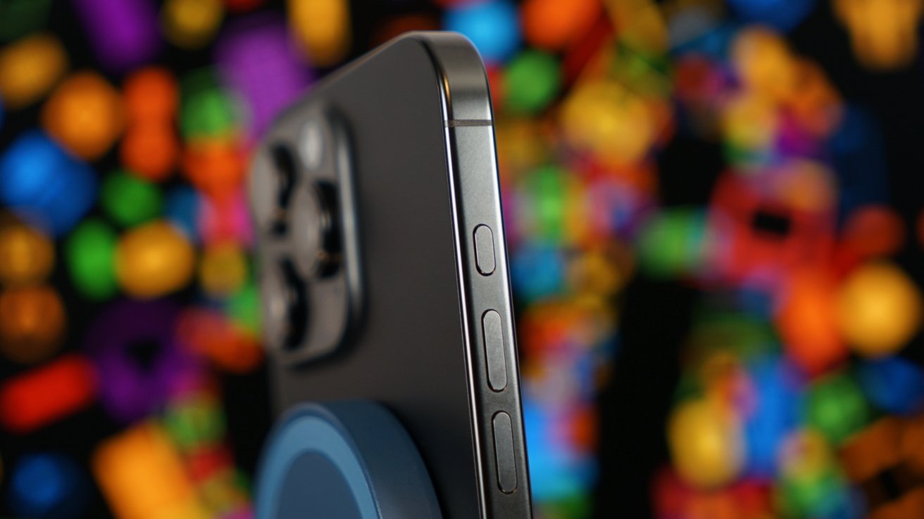 Close-up of a smartphone's edge with buttons and camera lenses, blurred colorful lights in the background.