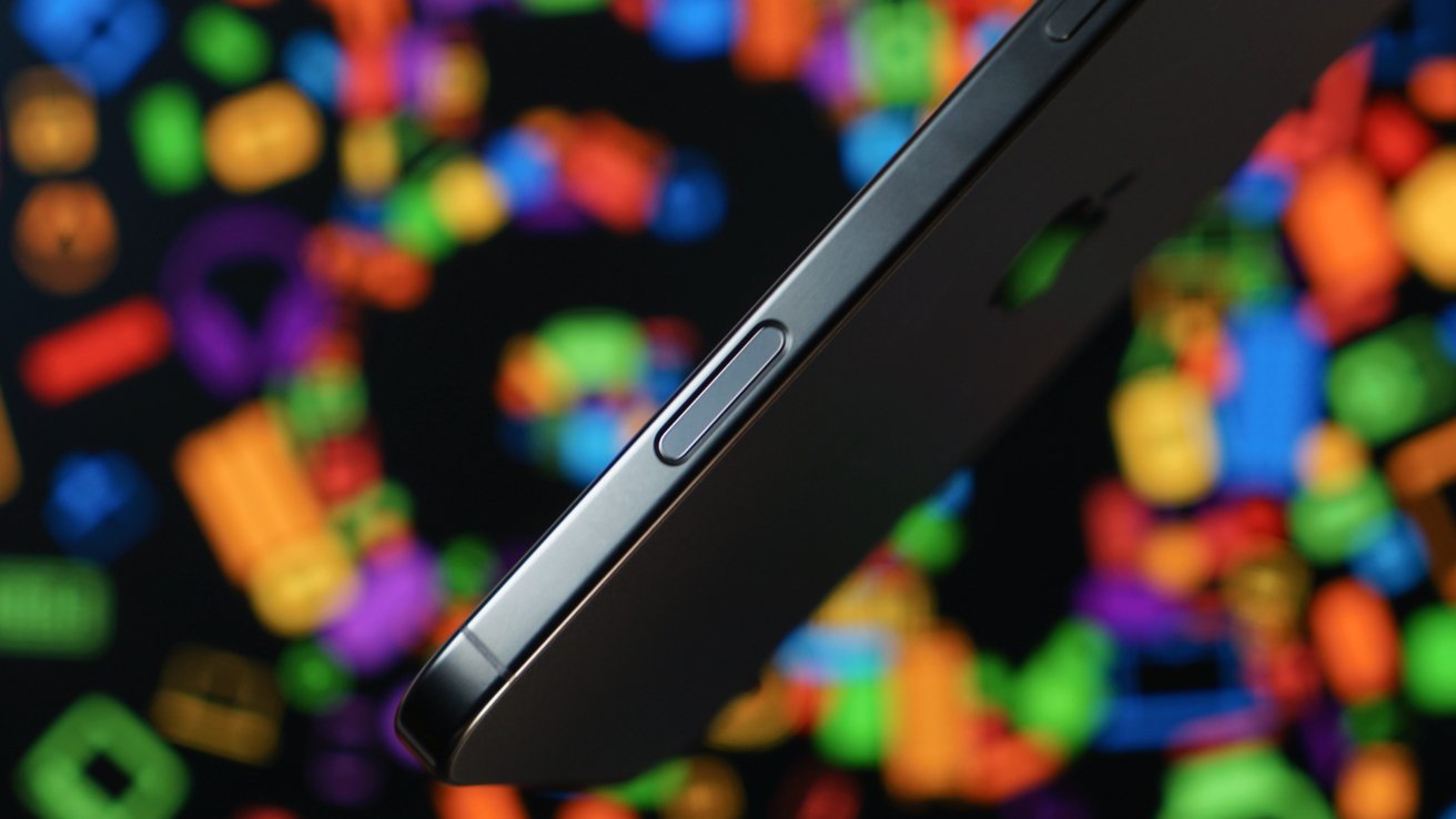 Side view of a smartphone with a colorful, out-of-focus background featuring various geometric shapes.