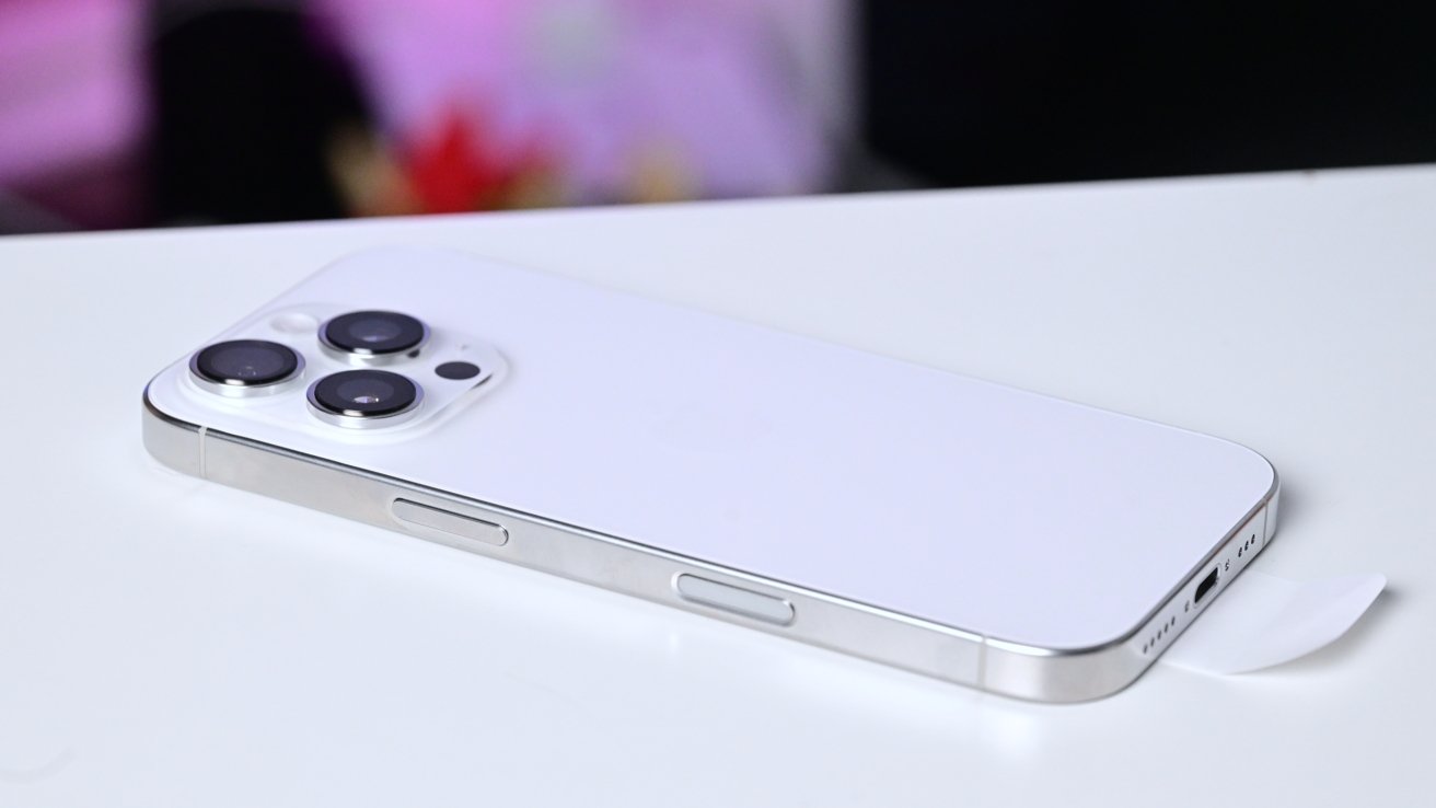 The white titanium iPhone 16 Pro on a white table