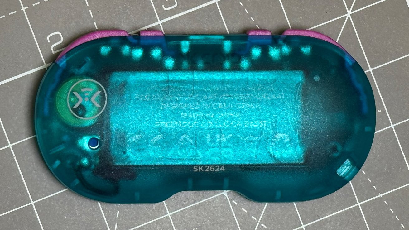 Translucent teal electronic board with a purple edge, featuring electronics symbols and a logo on a grid-patterned surface.