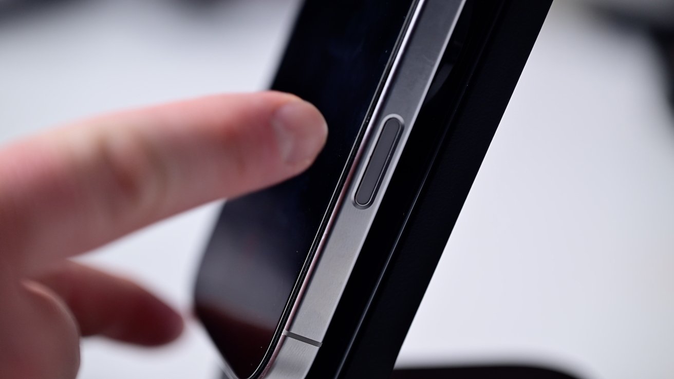 Close-up of a smartphone's triple camera lenses against a blurred purple and blue background.