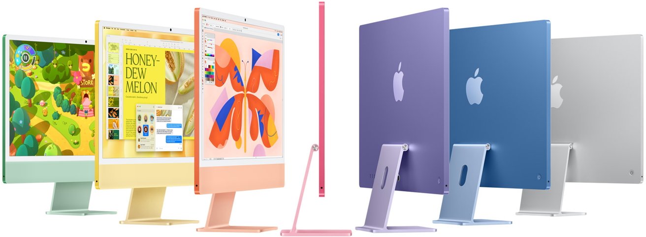 Seven colorful desktop computers displayed in green, yellow, orange, pink, purple, blue, and silver, with images and apps on their screens.