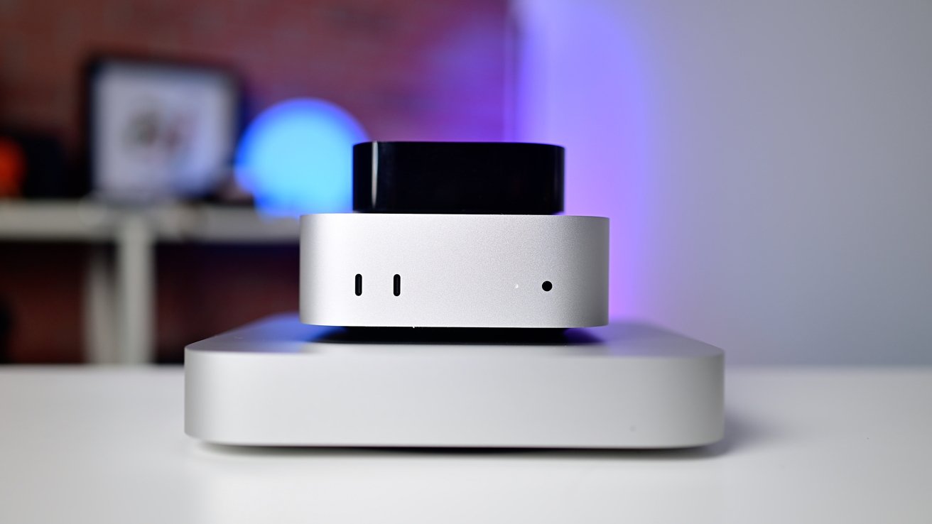 Three stacked electronic devices with sleek, rounded designs placed on a white surface. Background features a softly glowing blue light.