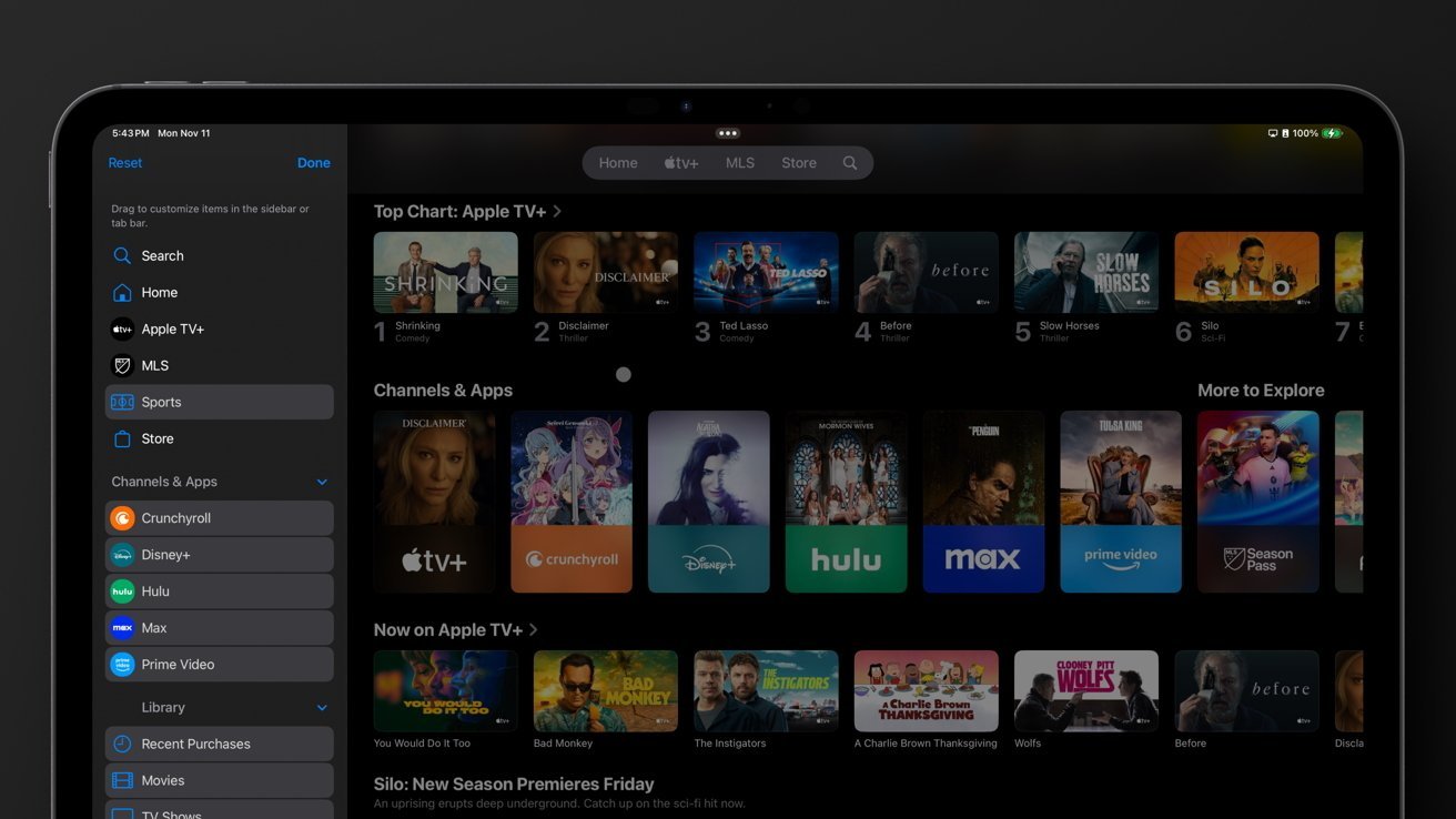 Tablet screen displaying a streaming app interface with navigation sidebar, top chart shows various TV show thumbnails, apps like Crunchyroll and Hulu, and a 'Now on Apple TV+' section.